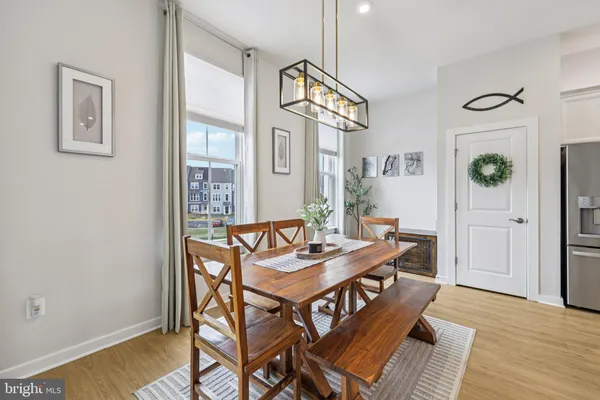 a living room with furniture kitchen and a chandelier