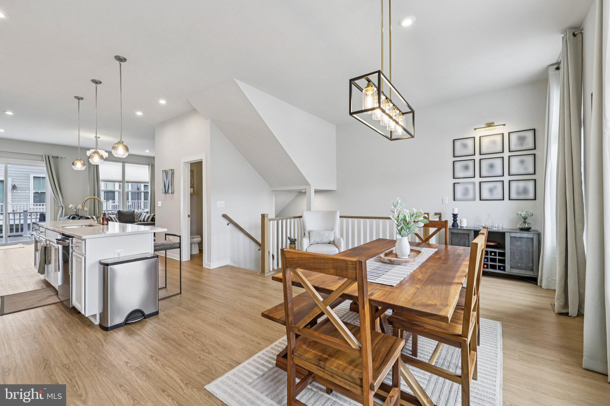 1687 Aspen Poplar Road Dumfries, VA 22026 - Photo 14 of 69 a dining room with wooden floor a chandelier a wooden table and chairs