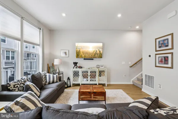 a living room with furniture and wooden floor