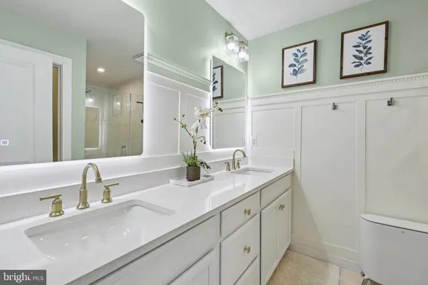 a bathroom with a sink mirror and toilet