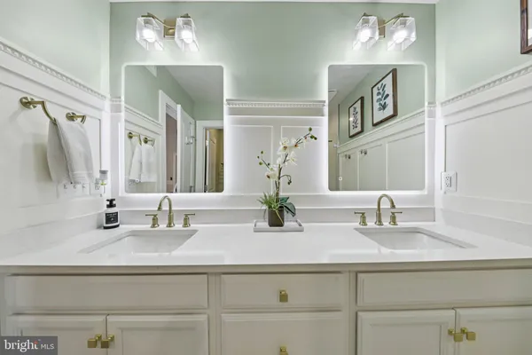 a bathroom with a toilet a sink and a mirror