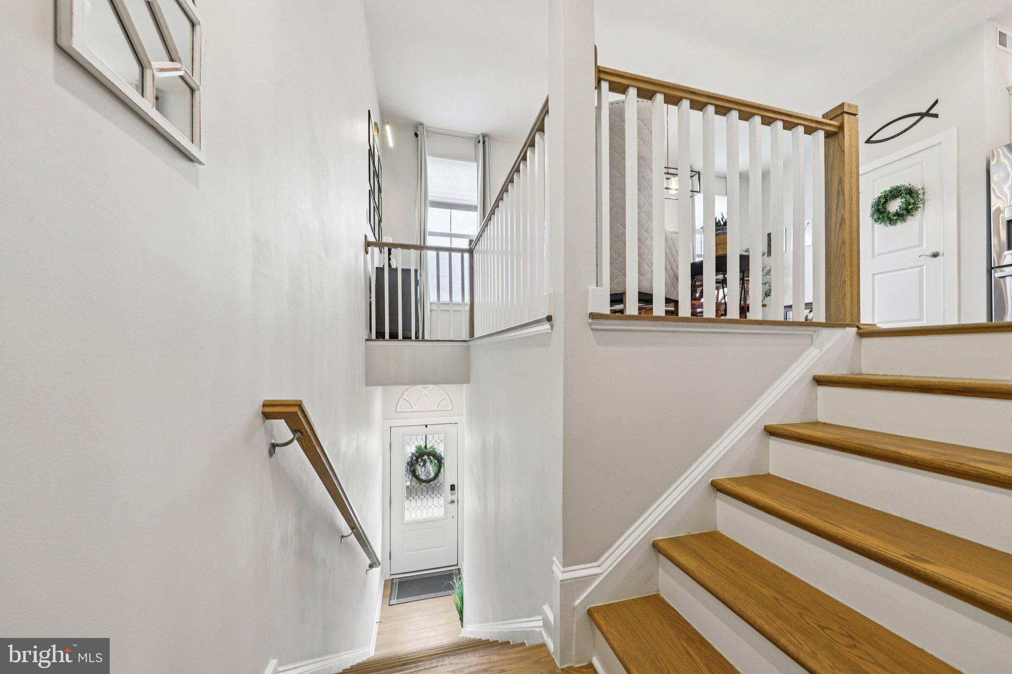1687 Aspen Poplar Road Dumfries, VA 22026 - Photo 3 of 69 a view of staircase with lots of frames on wall and a window