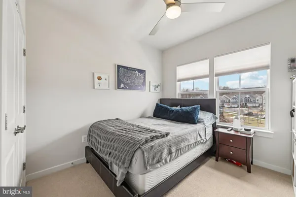 a bedroom with a bed and a mirror