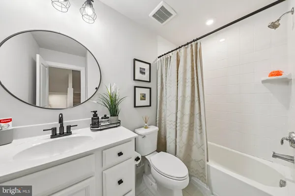 a bathroom with a sink a toilet and shower curtain