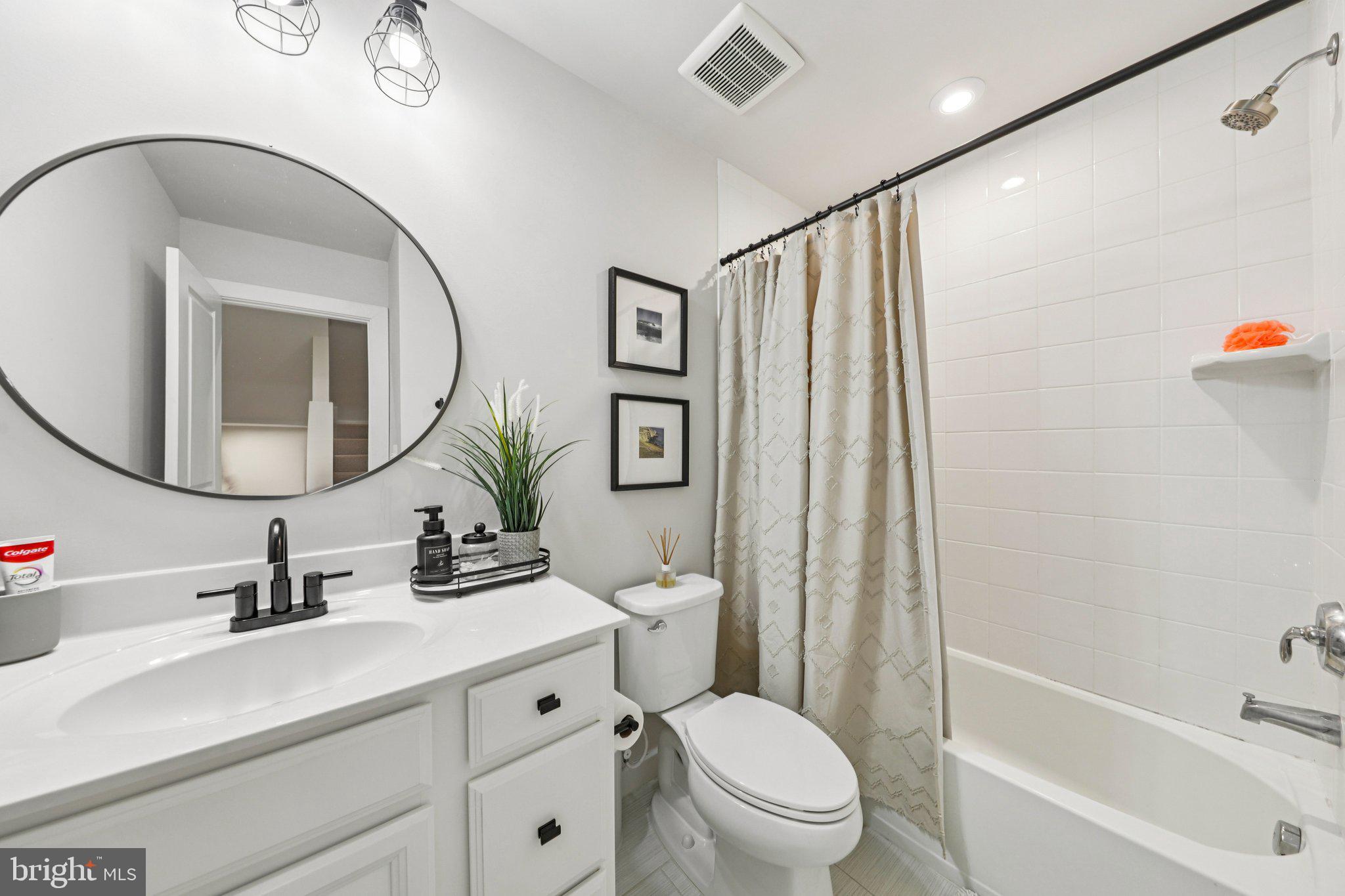 1687 Aspen Poplar Road Dumfries, VA 22026 - Photo 35 of 69 a bathroom with a toilet a sink and a mirror