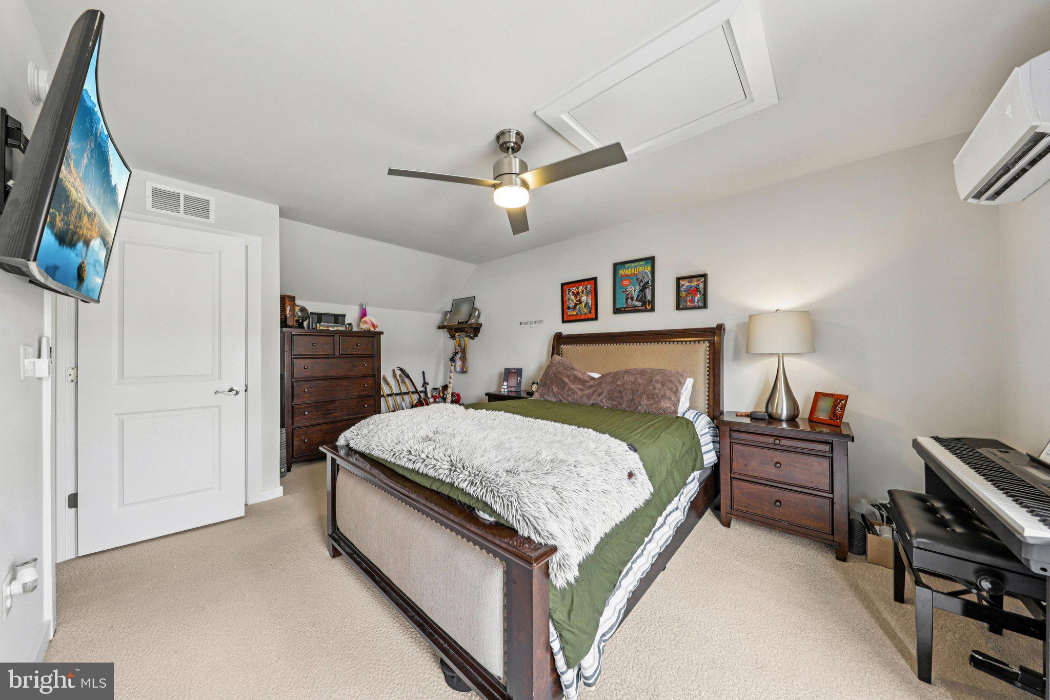 1687 Aspen Poplar Road Dumfries, VA 22026 - Photo 40 of 69 a bedroom with a bed and a chandelier