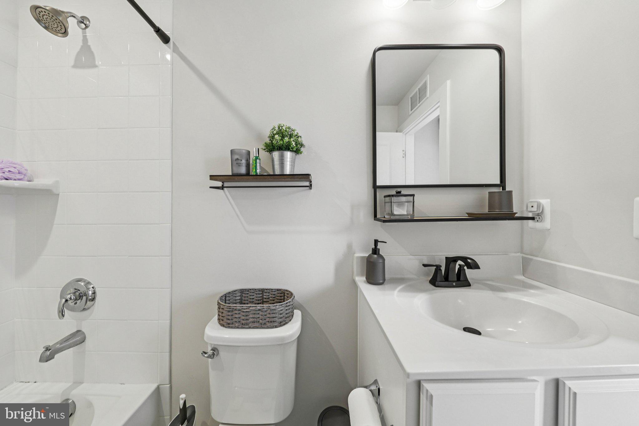 1687 Aspen Poplar Road Dumfries, VA 22026 - Photo 42 of 69 a bathroom with a toilet a sink and mirror