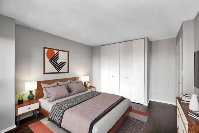 a bedroom with bed and cupboard