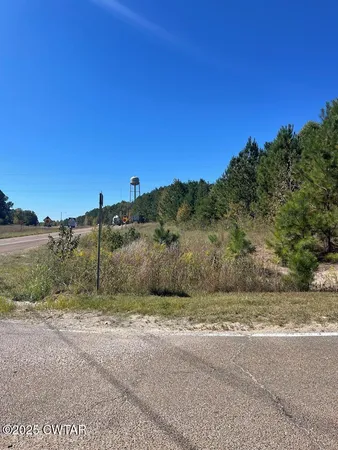 a view of a road with a building in the background