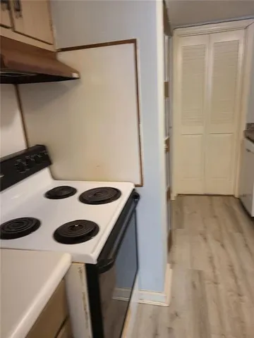a kitchen with a sink a refrigerator and a stove