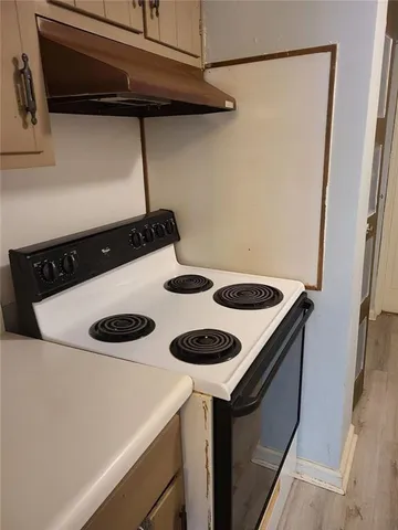 a kitchen with a stove and a refrigerator