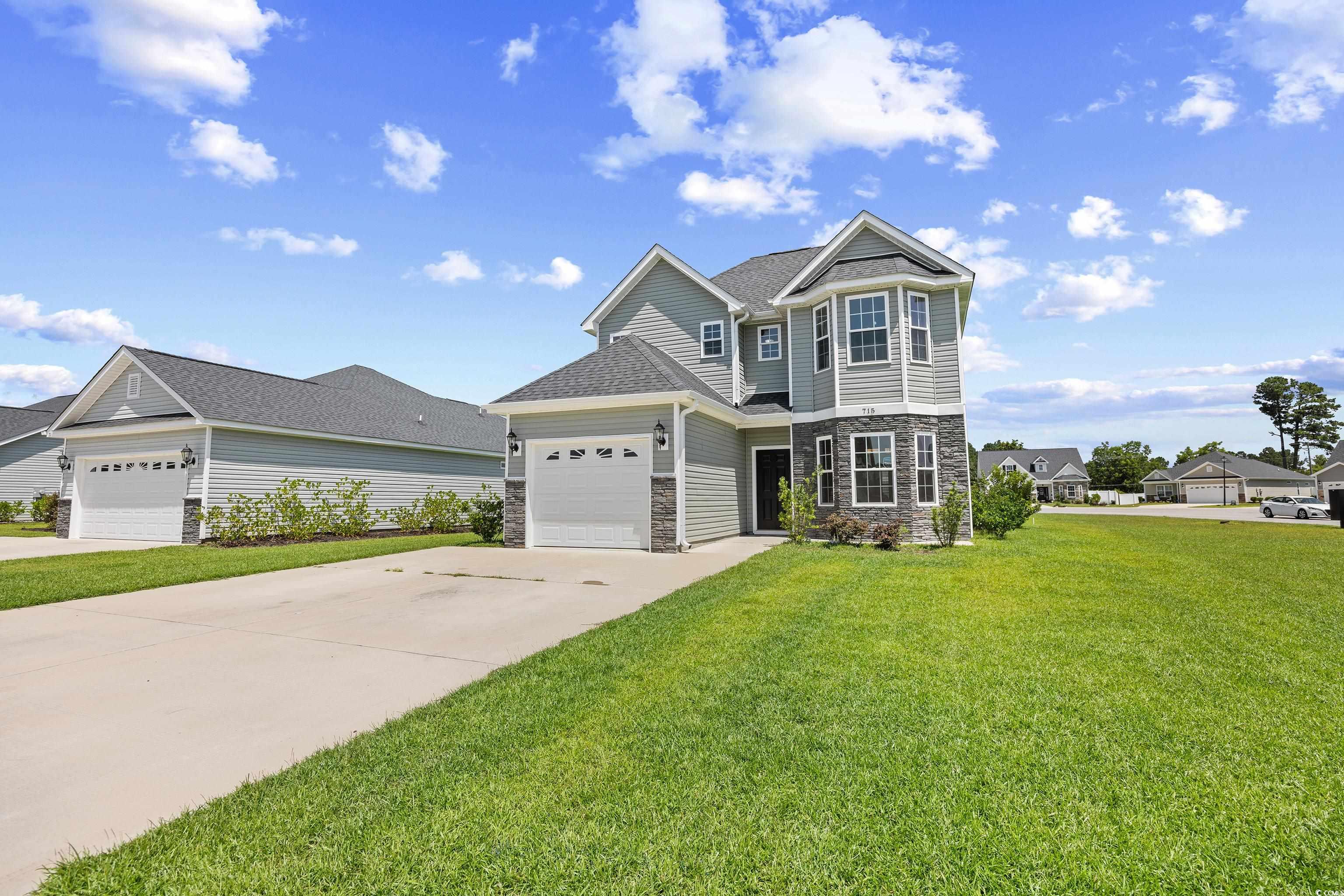 View of front of property featuring stone siding,