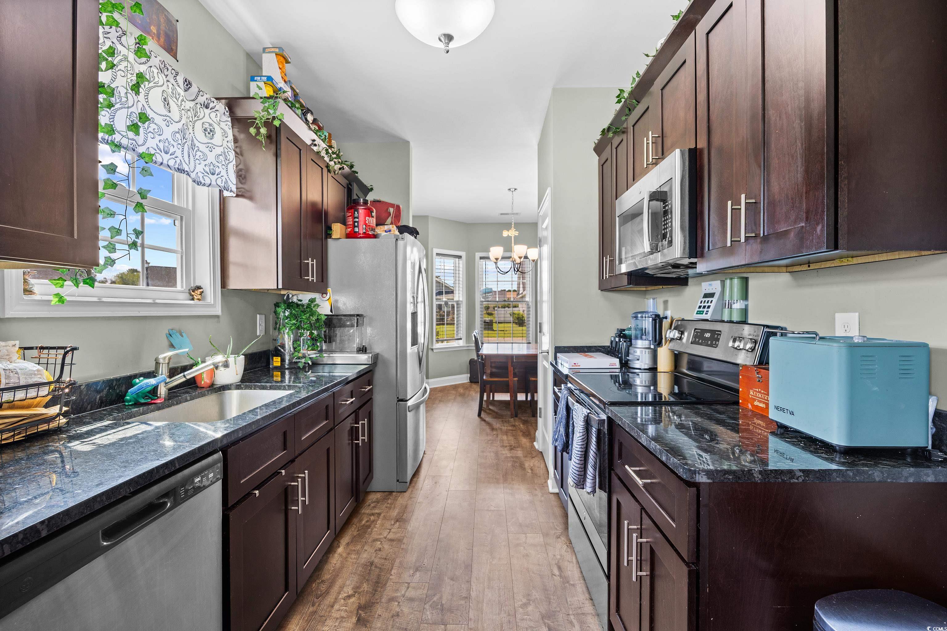 704 Hobonny Loop Longs, SC 29568 - Photo 11 of 36 Kitchen with stainless steel appliances, a chandel