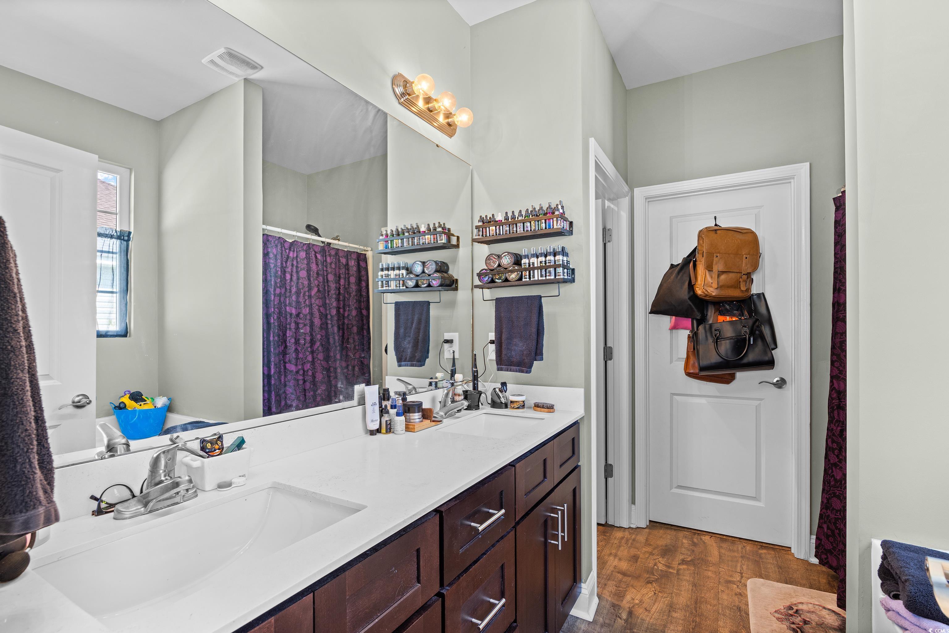 704 Hobonny Loop Longs, SC 29568 - Photo 20 of 36 Bathroom featuring double vanity, wood finished fl