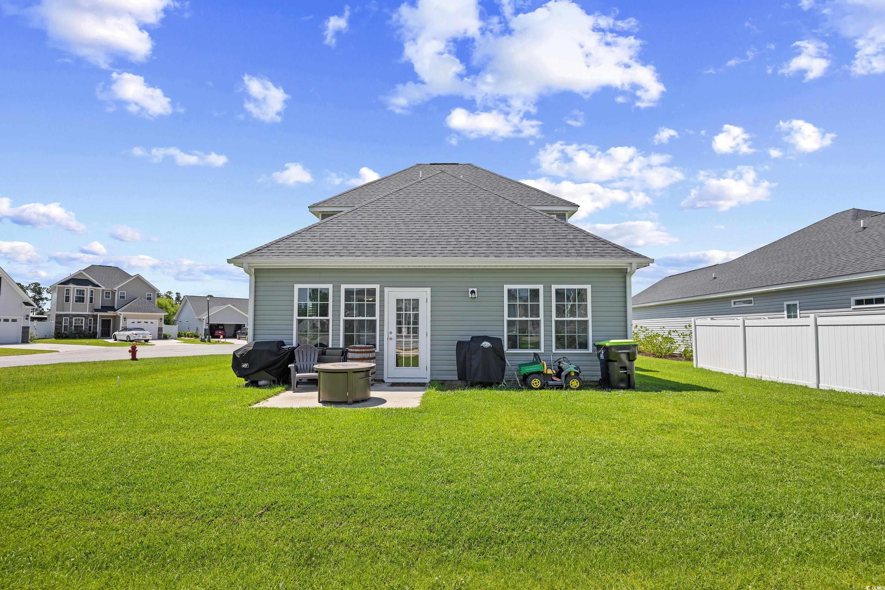 704 Hobonny Loop Longs, SC 29568 - Photo 33 of 36 Rear view of house featuring a shingled roof and a