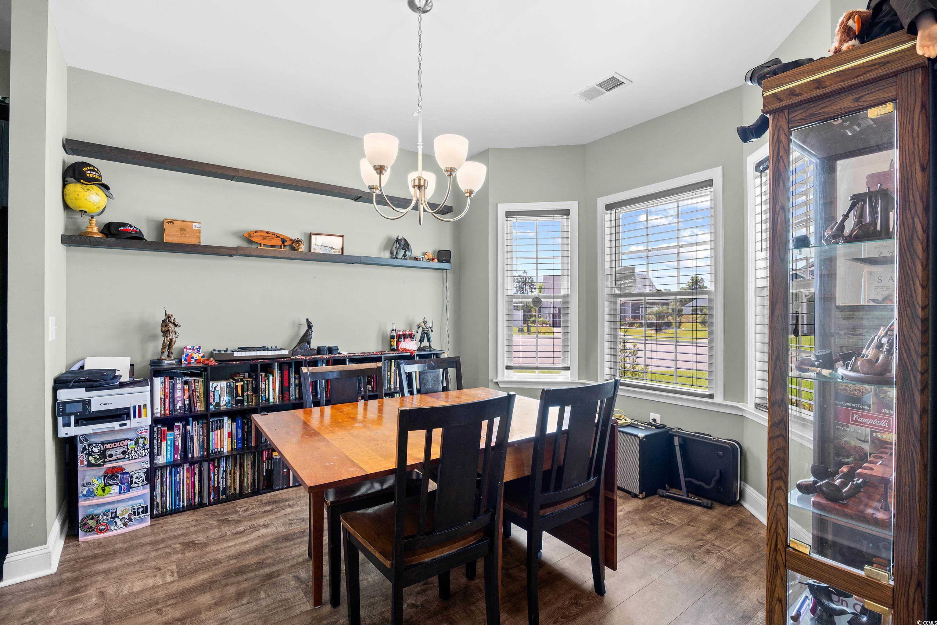 704 Hobonny Loop Longs, SC 29568 - Photo 4 of 36 Dining space with a chandelier and wood finished f