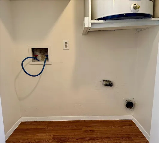 a view of a livingroom with wooden floor and a window