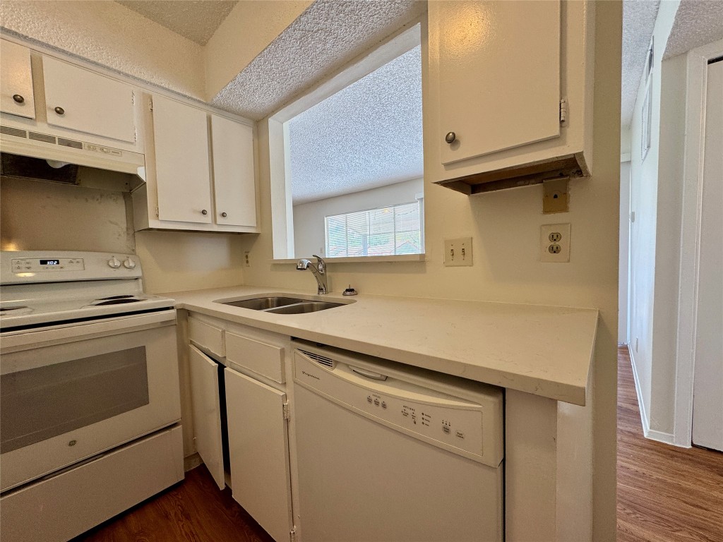 8905 Parkfield Drive, Unit 201 Austin, TX 78758 - Photo 5 of 13 a kitchen with stainless steel appliances white cabinets and a sink