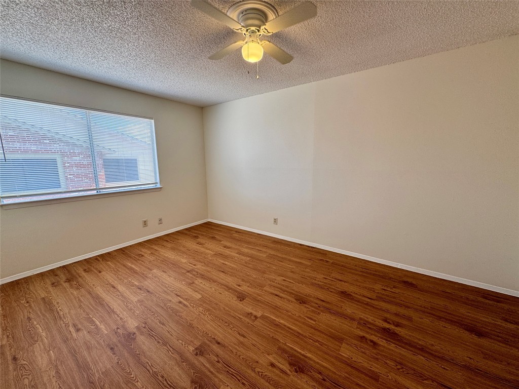 8905 Parkfield Drive, Unit 201 Austin, TX 78758 - Photo 7 of 13 a view of an empty room with window and wooden floor