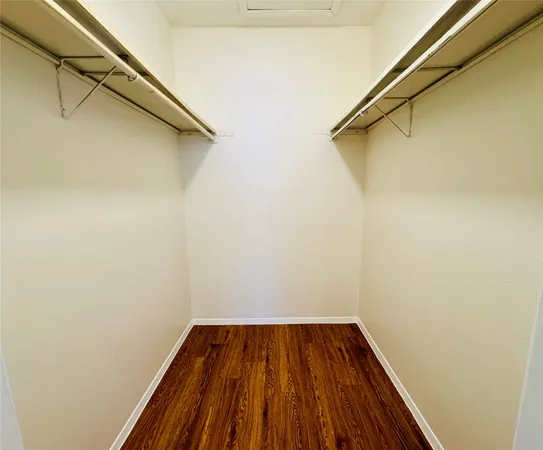 a view of a room with wooden floor and white walls