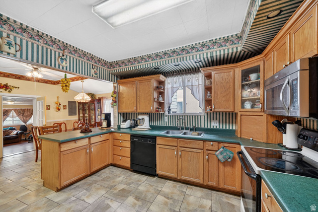 977 23rd Street Ogden, UT 84401 - Photo 15 of 29 Kitchen featuring black appliances, a peninsula, open shelves, dark countertops, and a wainscoted wall