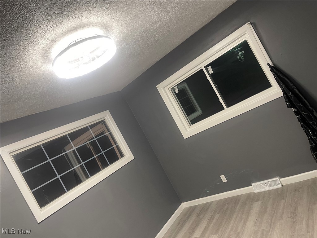603 Liberty Road Youngstown, OH 44505 - Photo 17 of 42 Unfurnished room featuring a textured ceiling and wood finished floors