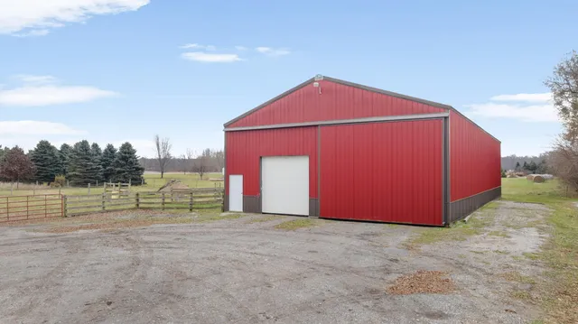 a view of backyard with seating area and barbeque oven