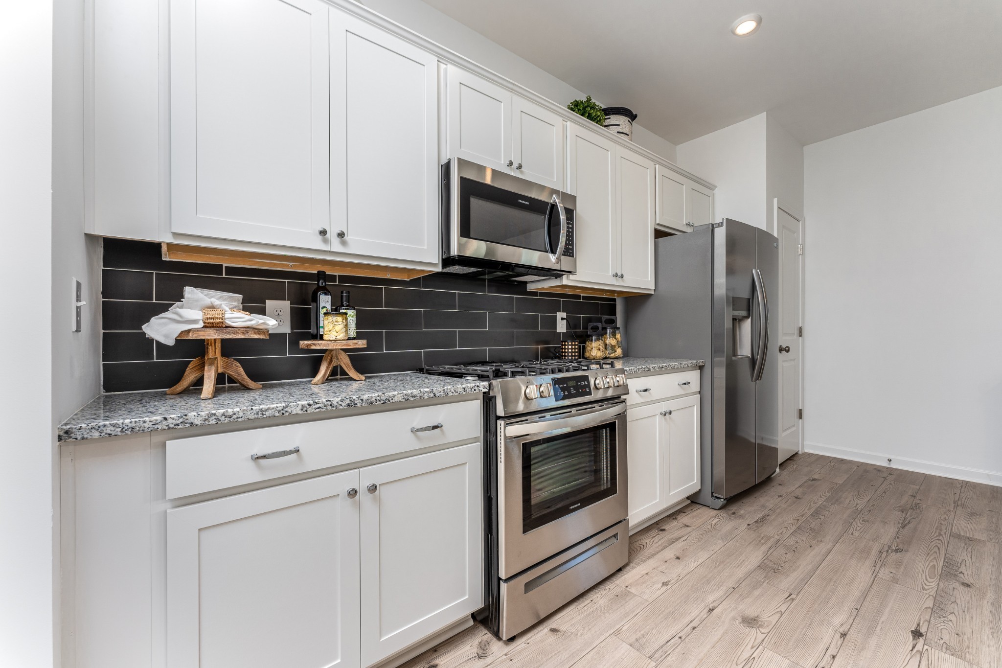 1116 Southerlynn Drive White House, TN 37188 - Photo 10 of 18 a kitchen with stainless steel appliances granite countertop a stove a refrigerator and a microwave