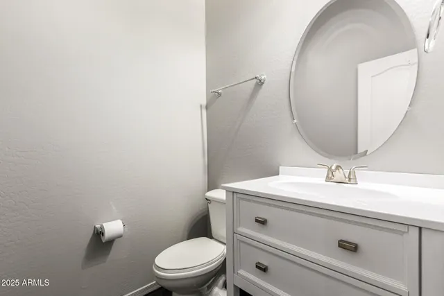 a bathroom with a sink a toilet and mirror
