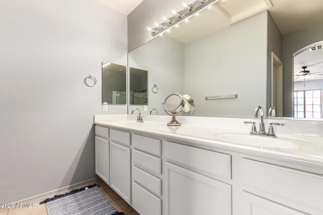 a bathroom with a double vanity sink and a mirror