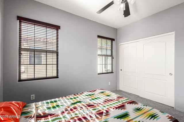 a bedroom with bed and a window