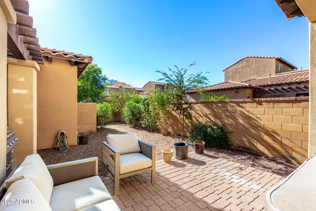 a view of a balcony with chairs and potted plants