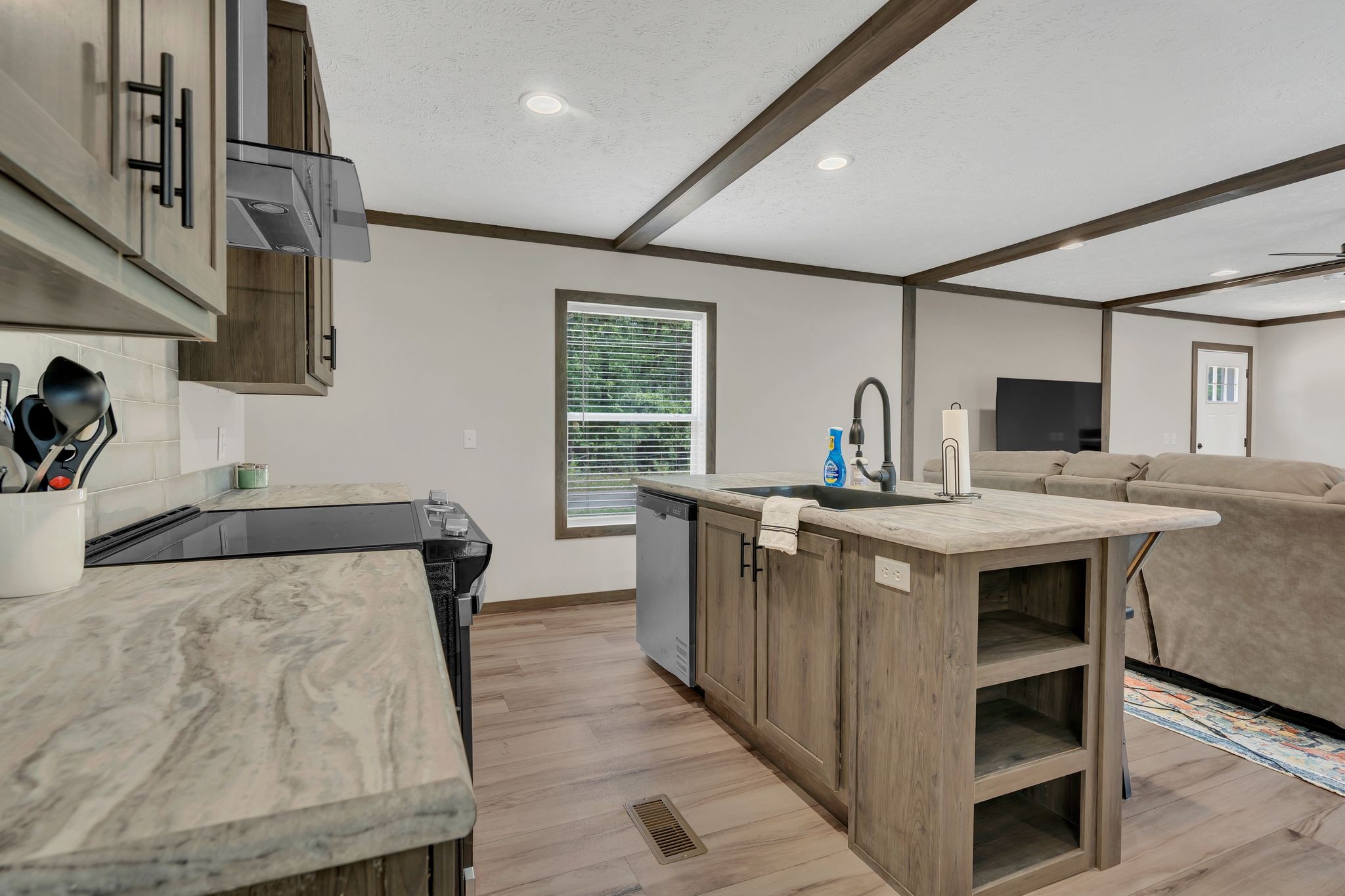 351 Wismer Road Camden, TN 38320 - Photo 11 of 27 a kitchen with stainless steel appliances granite countertop wooden cabinets a sink and a stove