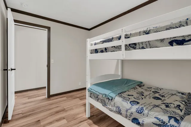 a kitchen with a stove and wooden floor