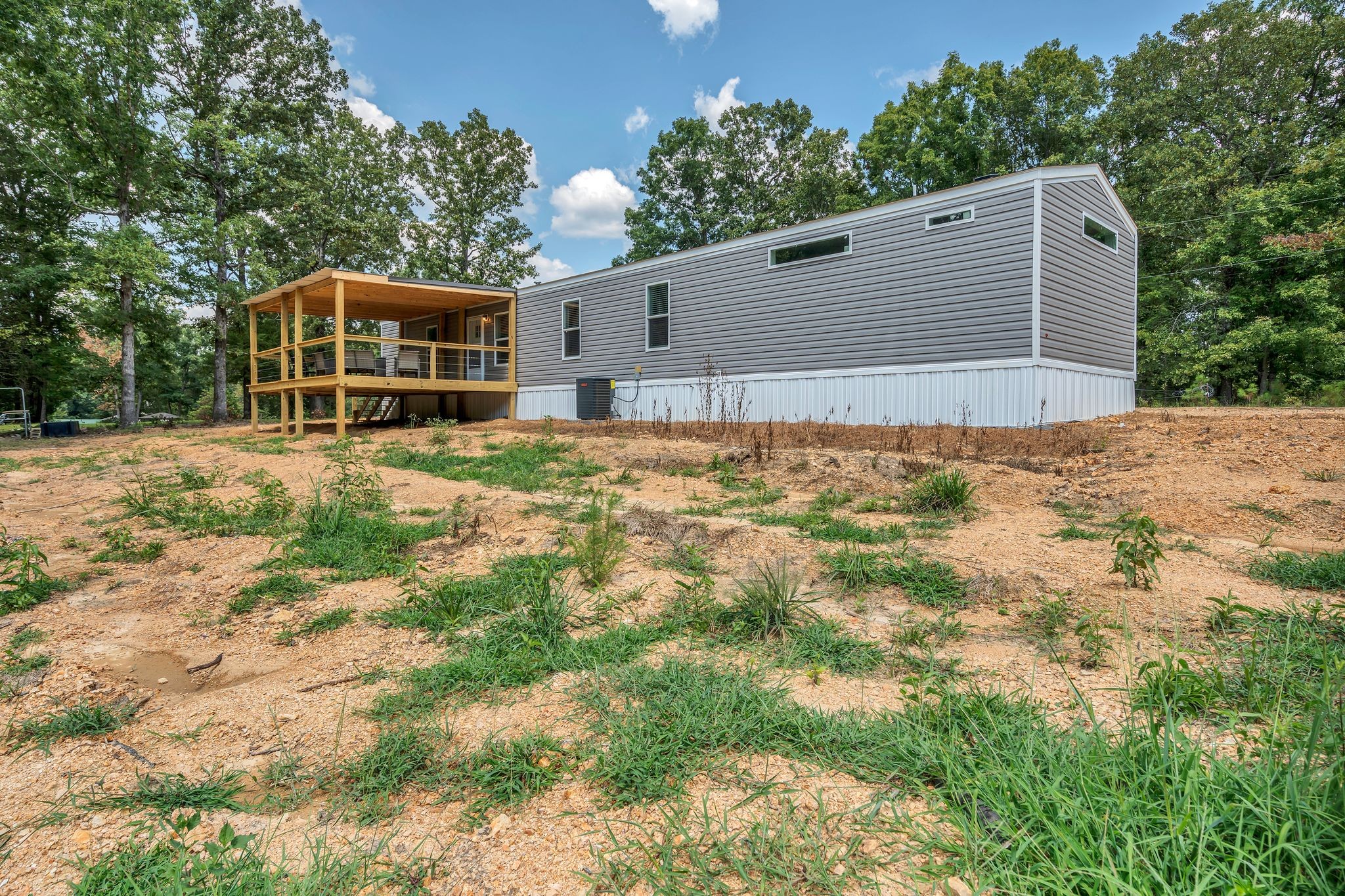 351 Wismer Road Camden, TN 38320 - Photo 26 of 27 a backyard of a house with large trees and outdoor space