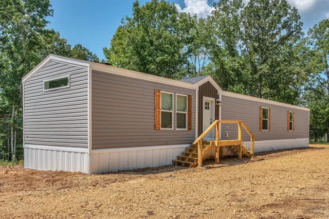 a view of a house with a backyard