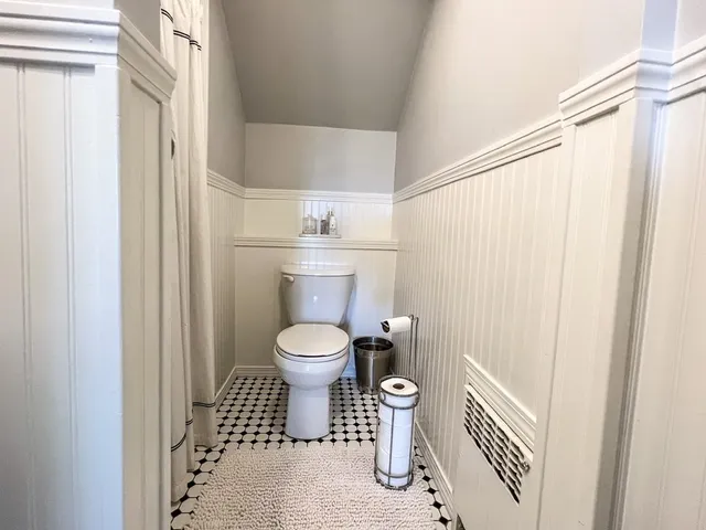 a bathroom with a toilet and a shower