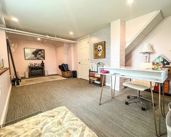 a workspace with furniture wooden floor and windows