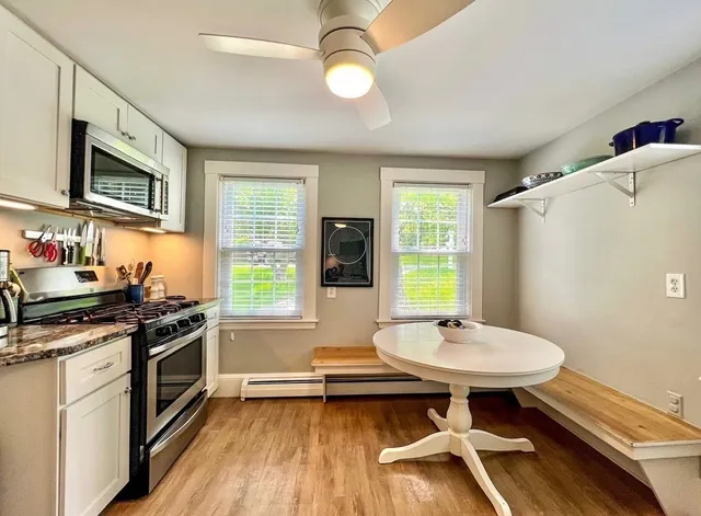 a kitchen with stainless steel appliances a stove a sink and a microwave