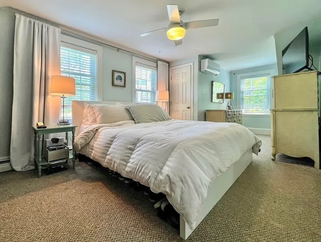 a bedroom with a bed dresser and a window