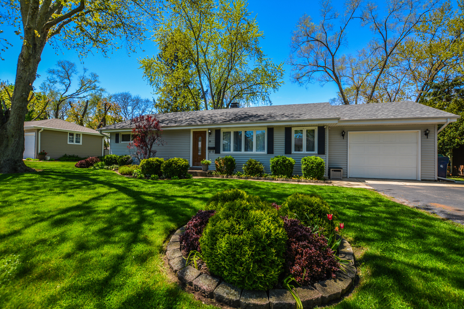 a view of an house with backyard space and garden