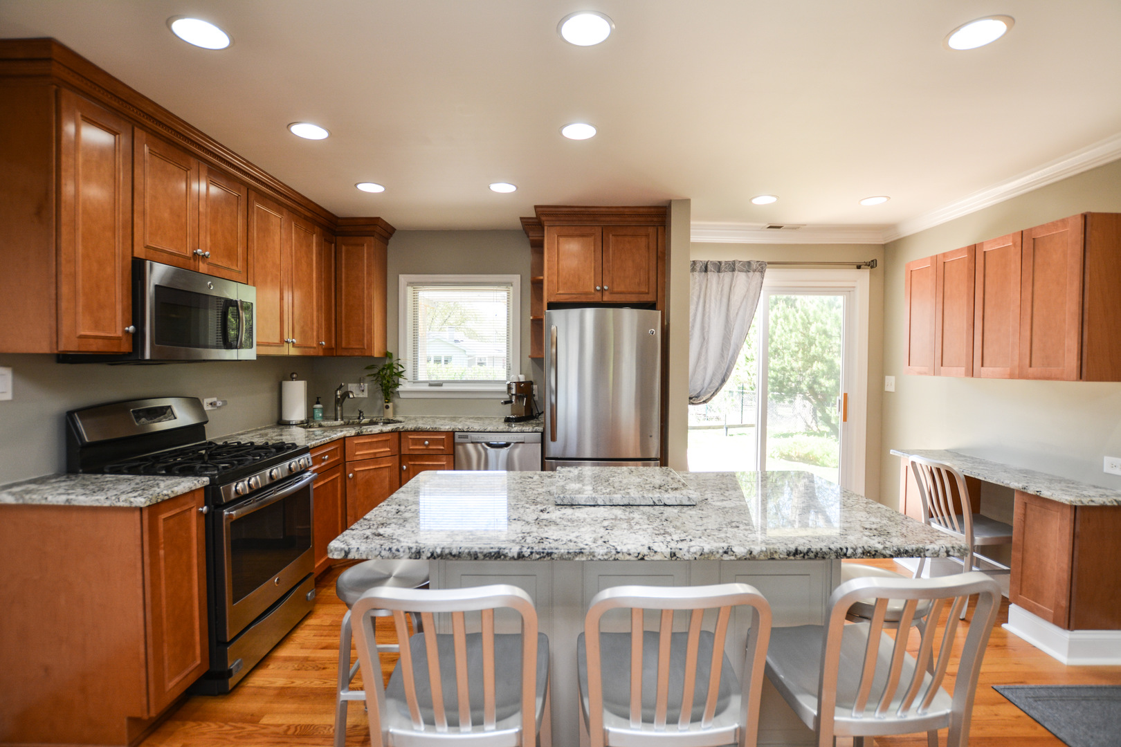 36 Johnathan Road Lake Zurich, IL 60047 - Photo 16 of 25 a kitchen with stainless steel appliances granite countertop a stove a sink a microwave a refrigerator and cabinets