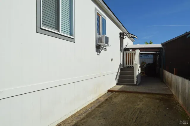 a view of a hallway with closet and a window