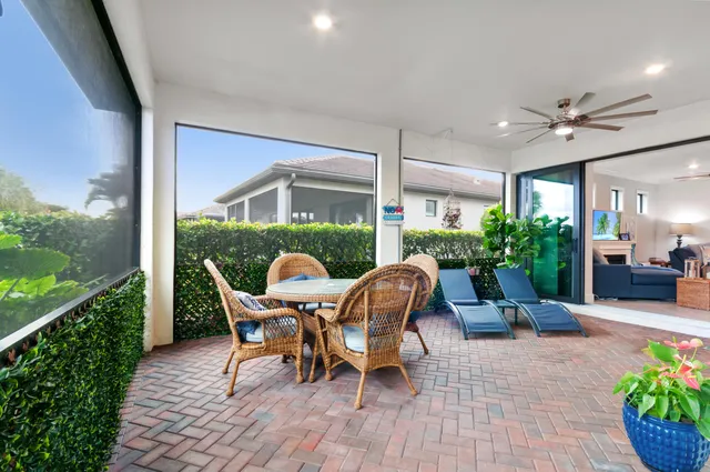 a view of a house with backyard sitting area and garden