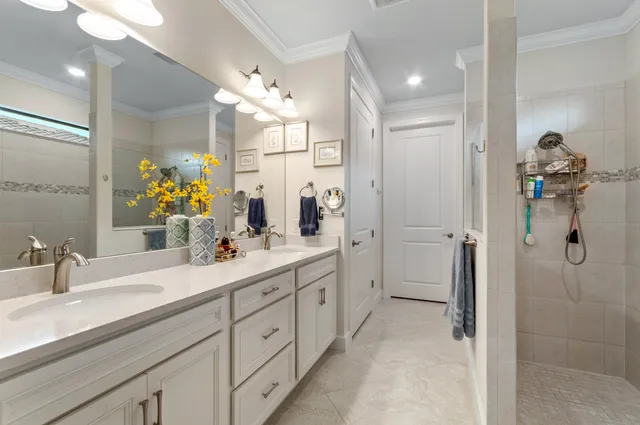 a bathroom with a double vanity sink mirror and shower