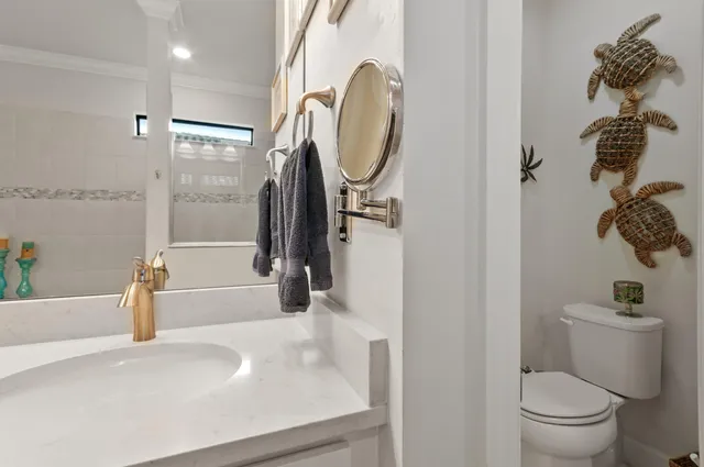 a bathroom with a sink a toilet and a shower