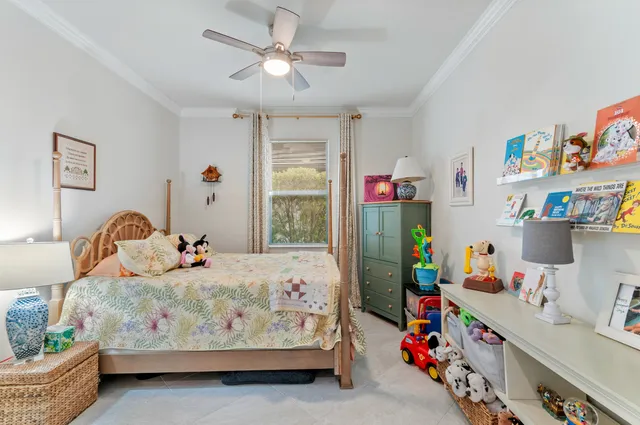 a bedroom with baby bed toys and dresser