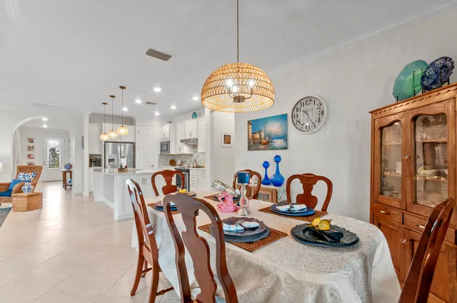 a dining room with furniture and a chandelier