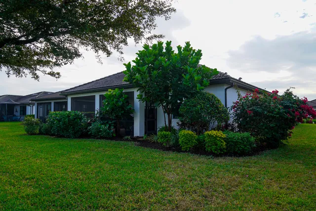 a front view of a house with a garden
