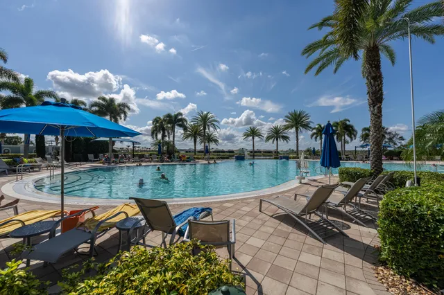 a view of a lake with a garden and a patio